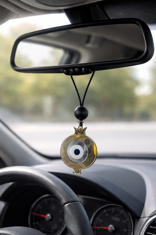 Car dashboard with an evil eye hanging ornament