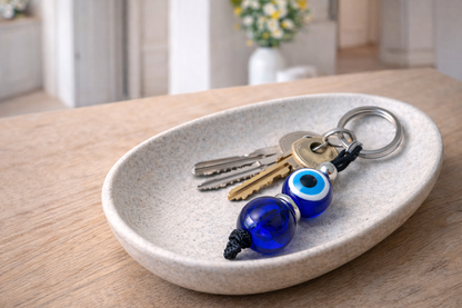 Greek-inspired evil eye keychain with a bold blue bead and durable metal ring, ideal for keys, purses, or travel bags.