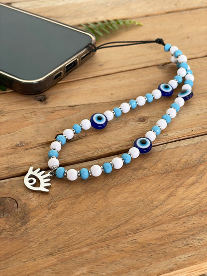 Protective evil eye cellphone strap featuring blue glass eye beads and a beaded wrist lanyard.