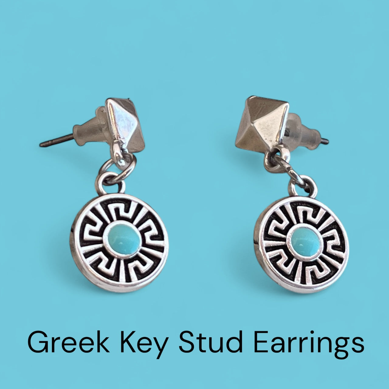 Greek Key Stud Earrings on a blue background