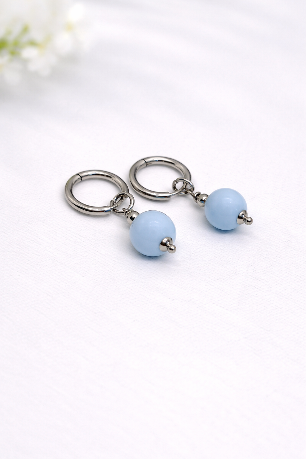 Keychain with light blue beads on a white background