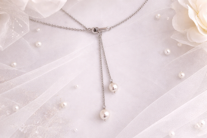 Pearl necklace on a white fabric background