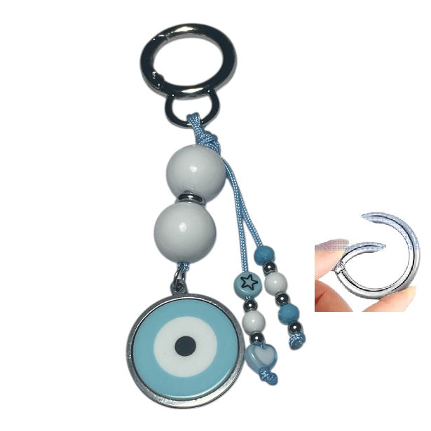 Keychain with blue and white evil eye design on a white background