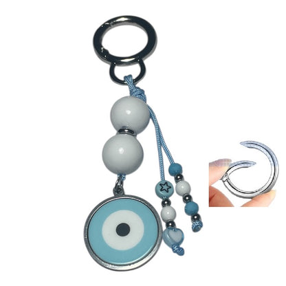 Keychain with blue and white evil eye design on a white background