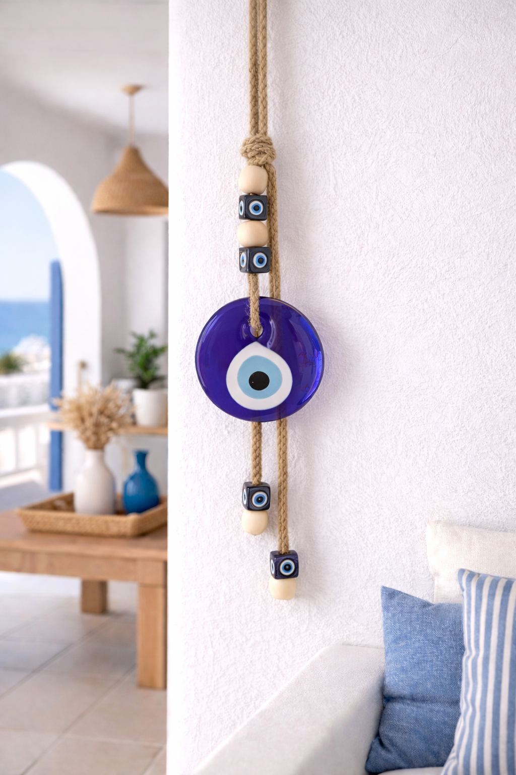 Handmade Greek glass evil eye wall hanging for protection displayed in a Cycladic home.
