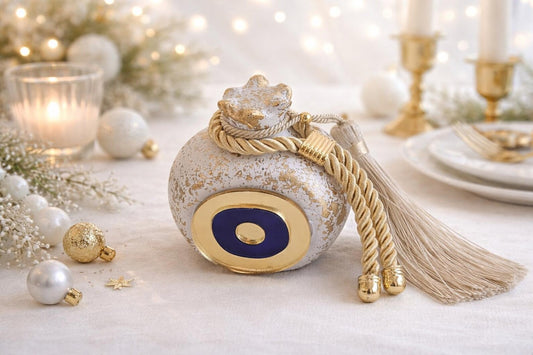 Decorative bottle with tassel on a festive table setting with candles and ornaments.