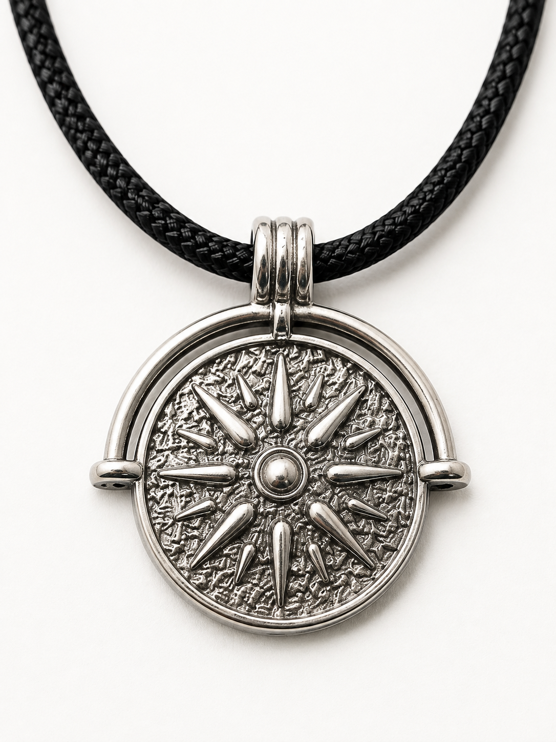 A silver-toned compass sun pendant necklace on a black braided cord, shown against a plain white background.