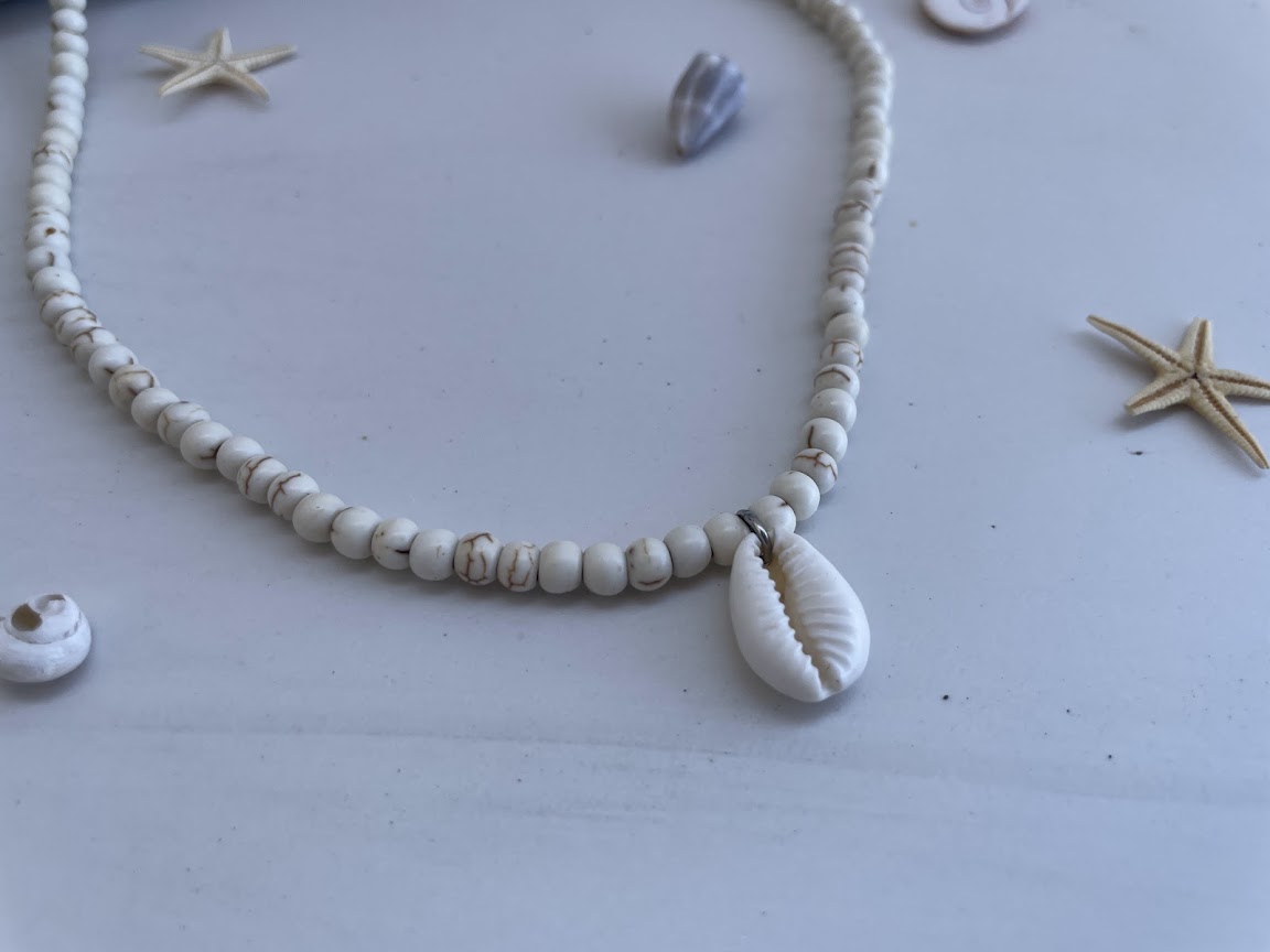Necklace with shell beads on a light background