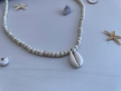 Necklace with shell beads on a light background
