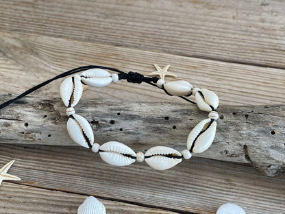 Necklace with cowrie shells on a wooden surface