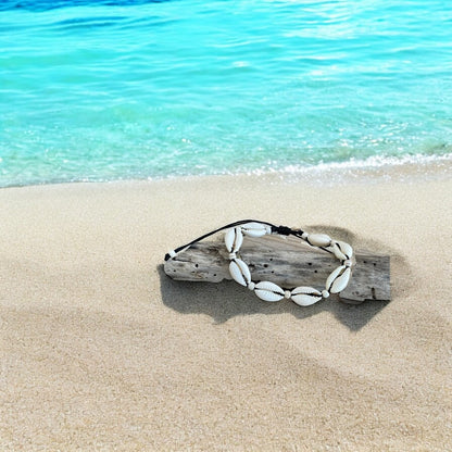 Shell headband on a piece of driftwood by the ocean