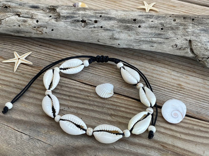 Necklace with shell beads on a wooden surface with starfish