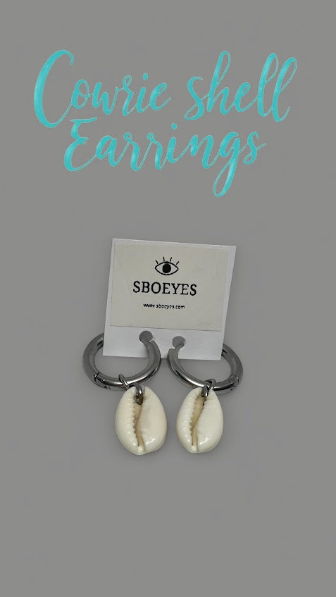 Cowrie shell earrings on a gray background with 'SBOEYES' branding.