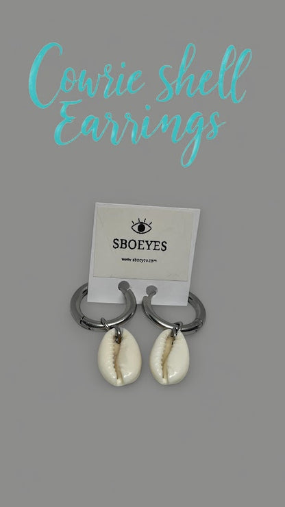 Cowrie shell earrings on a gray background with 'SBOEYES' branding.