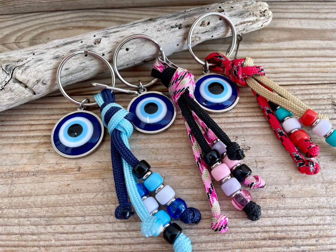 Colorful keychains with eye designs on a wooden surface