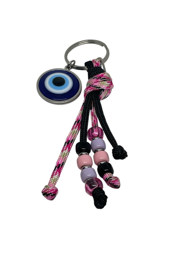 Keychain with colorful beads and an evil eye charm on a white background