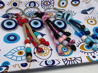 Keychains with colorful beads on a decorative tray with eye designs