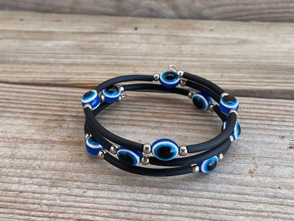 Multilayered bracelet with blue and silver accents on a wooden surface