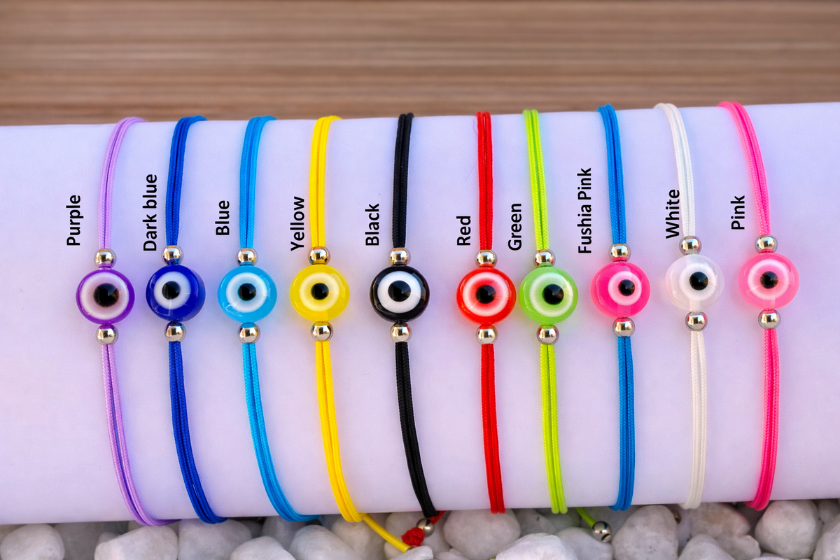 Set of colorful bracelets with evil eye charms on a white surface.