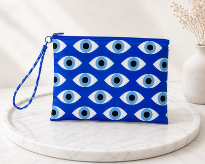Handmade blue evil eye pouch with Greek mati pattern on a marble surface.