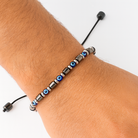 Bracelet with blue and silver beads on a wrist against a white background