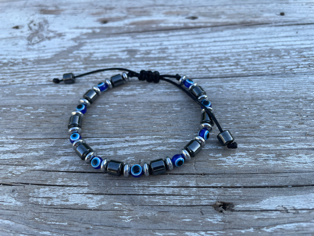 Beaded bracelet with blue and black beads on a wooden surface