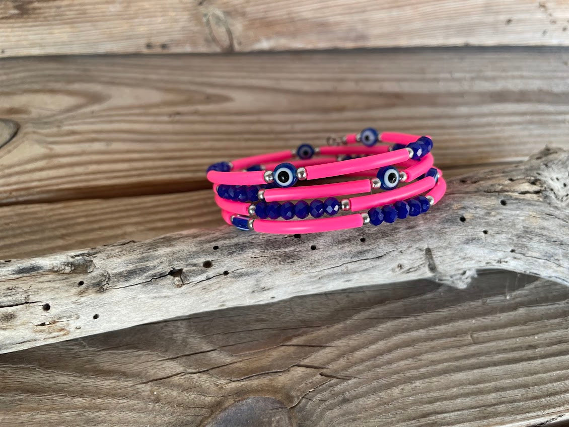 Pink and blue beaded bracelet on a wooden surface