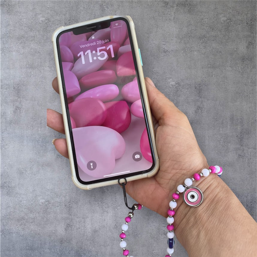 Hand holding a smartphone with a colorful screen against a gray background