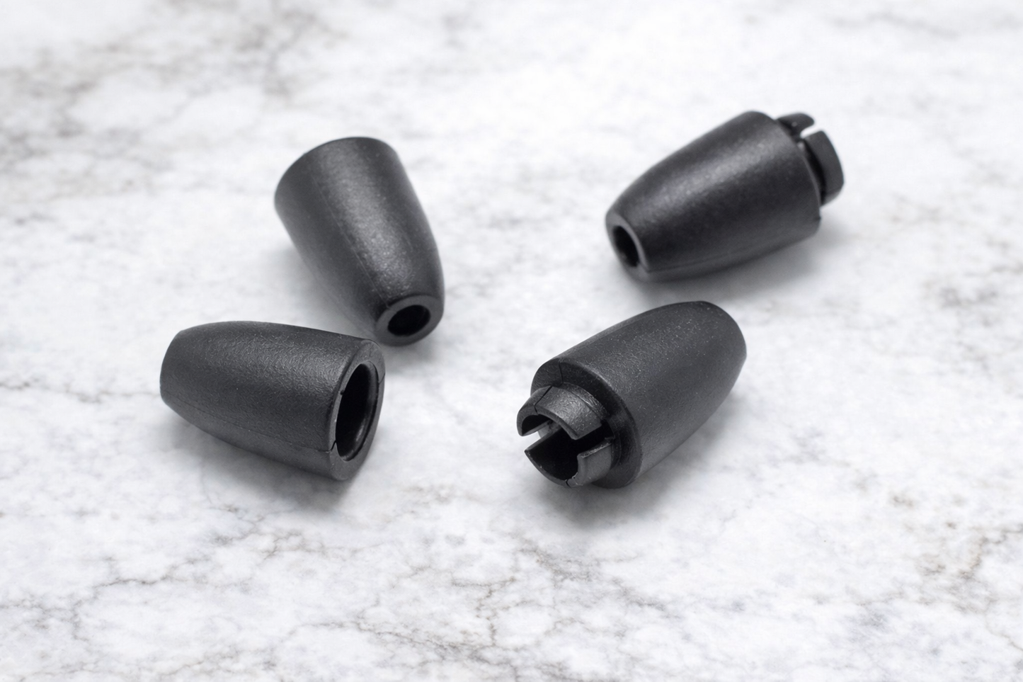 Four black plastic claspdon a textured white background