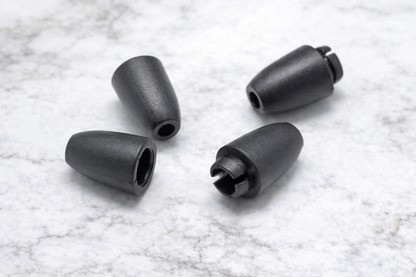 Four black plastic claspdon a textured white background