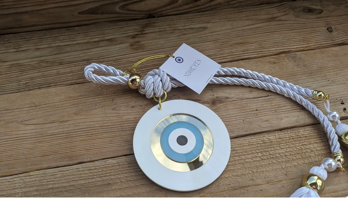 Decorative hanging ornament with a circular design on a wooden surface