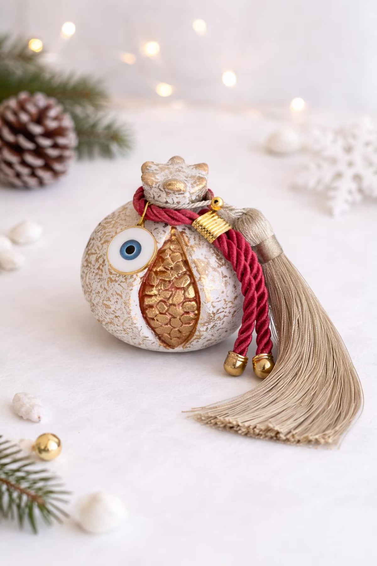 Decorative ornament with tassel and red ribbon on a light background