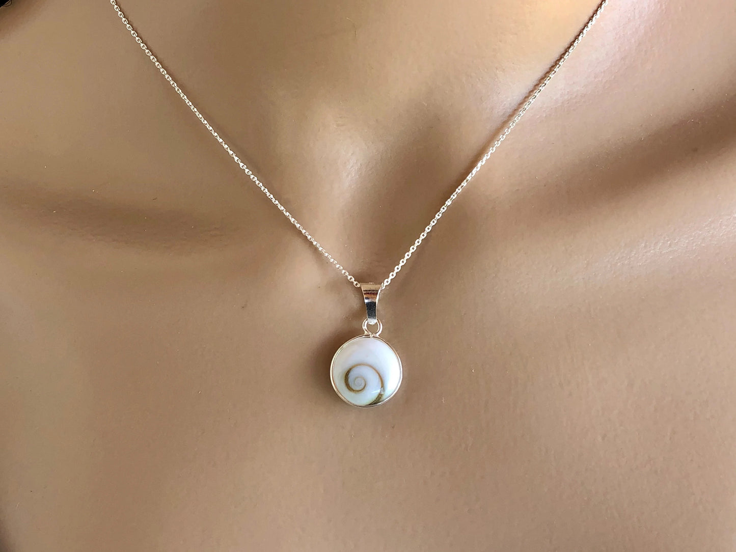 Necklace with a shell pendant on a mannequin
