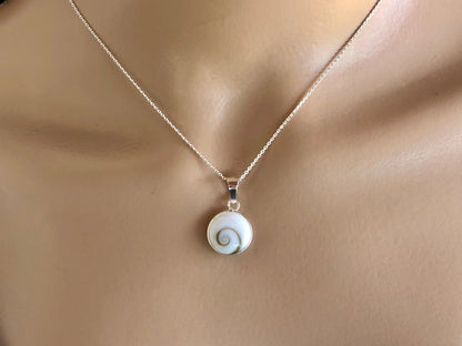 Necklace with a shell pendant on a mannequin