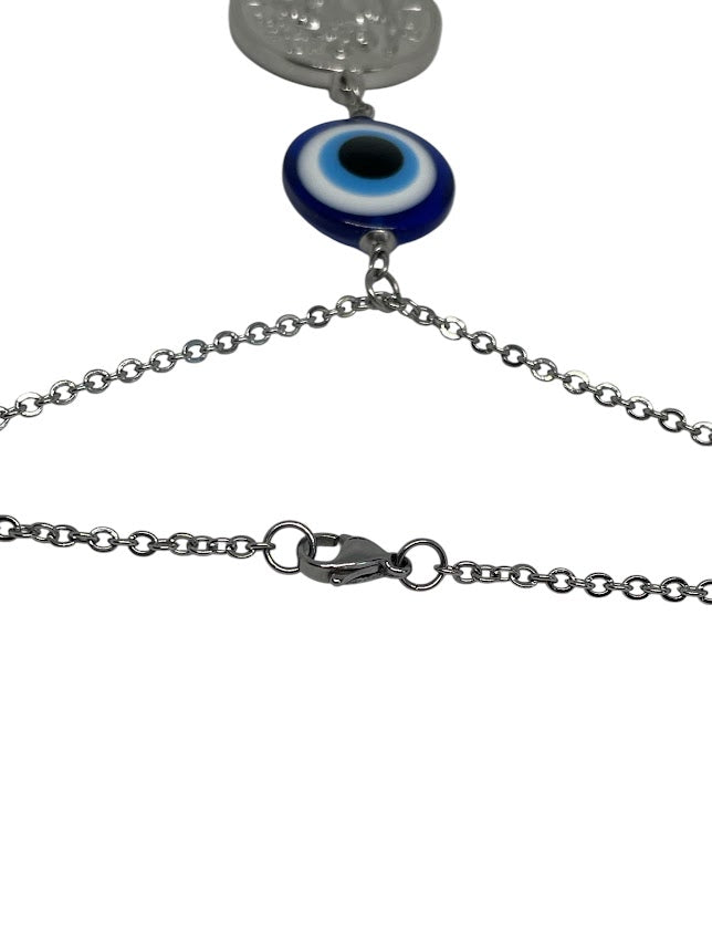 Silver chain necklace with a blue evil eye pendant on a white background