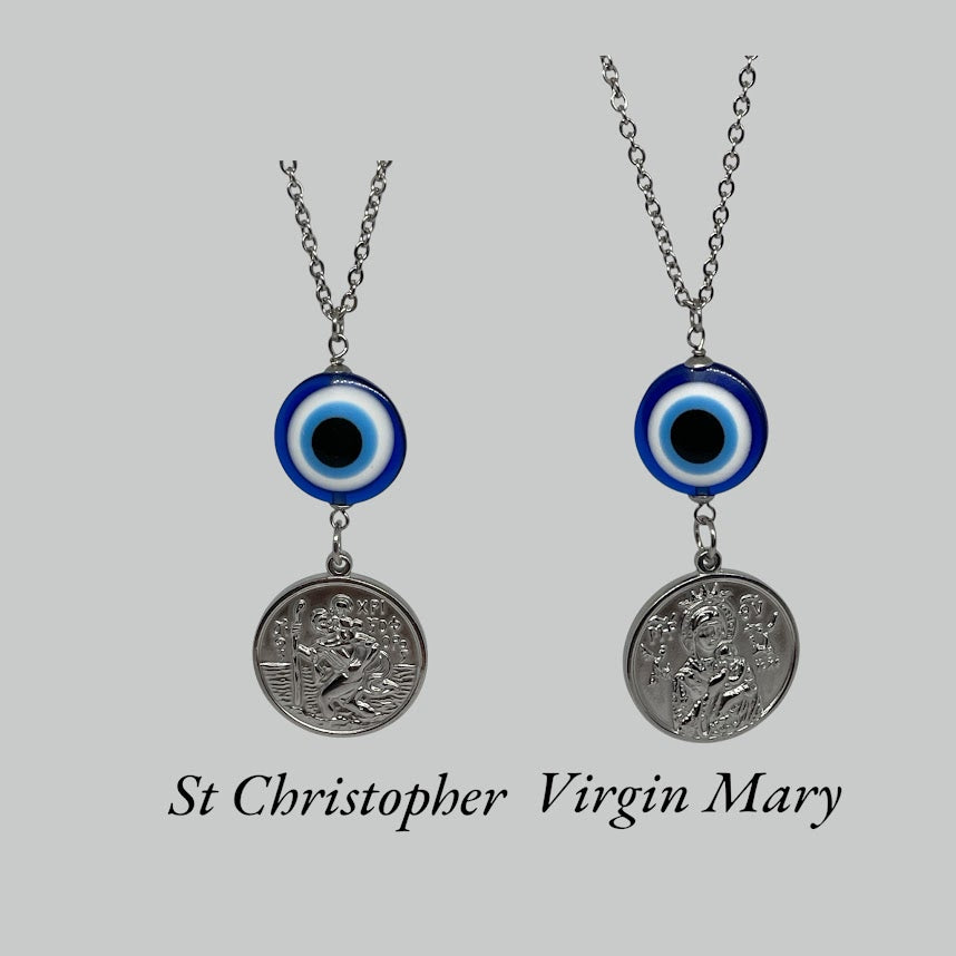 Two necklaces with St Christopher and Virgin Mary pendants on a gray background
