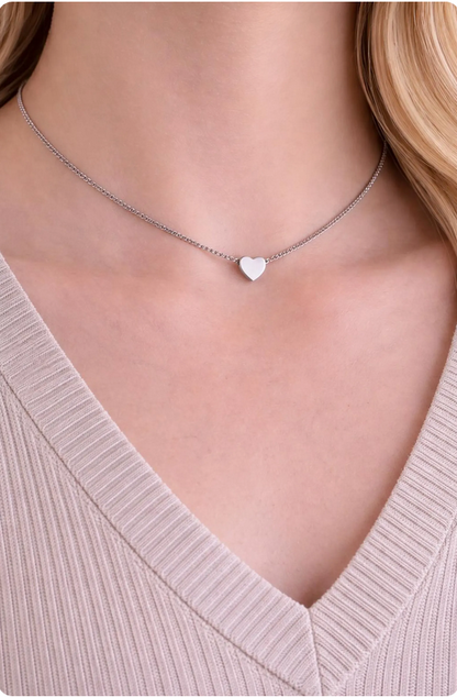 Necklace with a heart pendant worn by a person