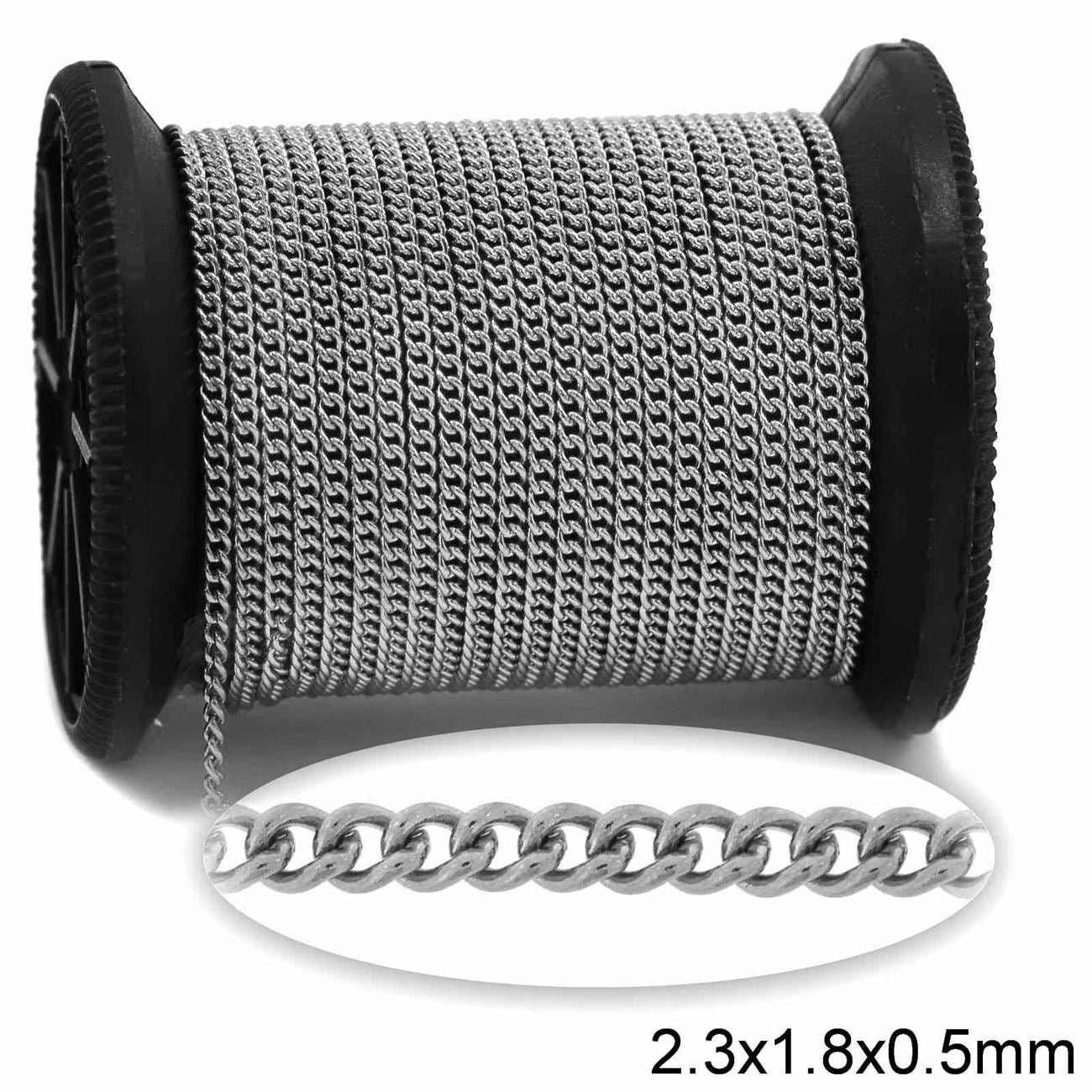 Spool of silver chain with a single chain on a white background.
