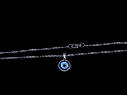 A stainless steel curb chain necklace with a round blue glass evil eye charm pendant.