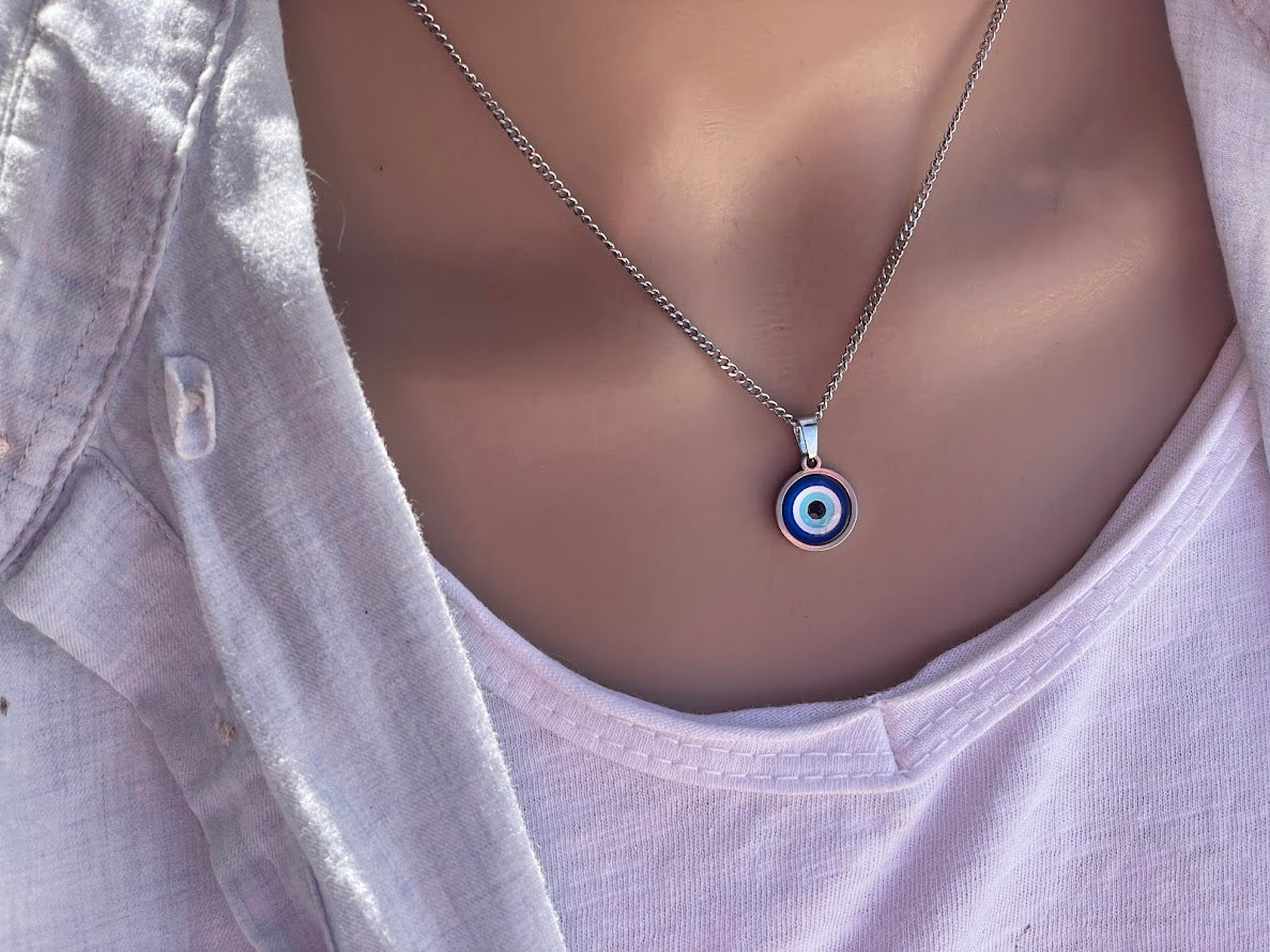 Necklace with a blue eye pendant on a mannequin.
