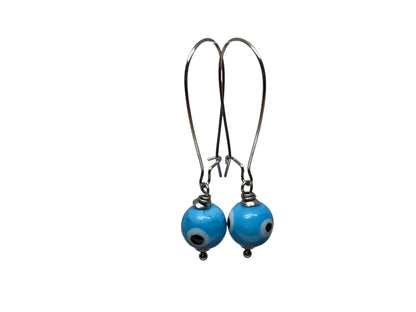 Pair of blue beaded earrings on a white background