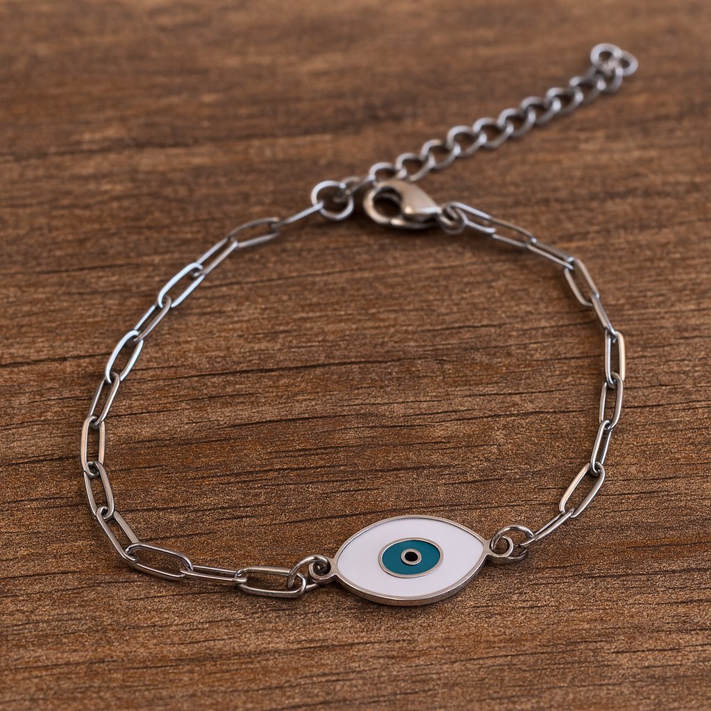 Silver chain bracelet with an eye charm on a wooden surface