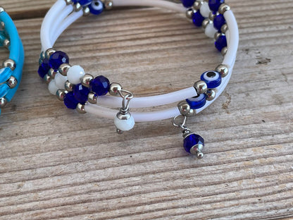 Beaded bracelet with blue and white beads on a wooden surface