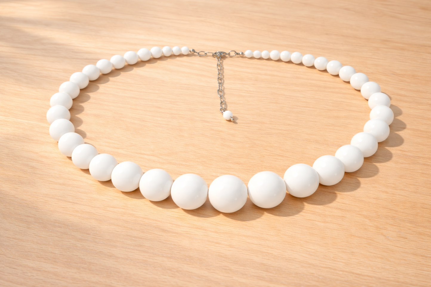 White beaded necklace on a wooden surface