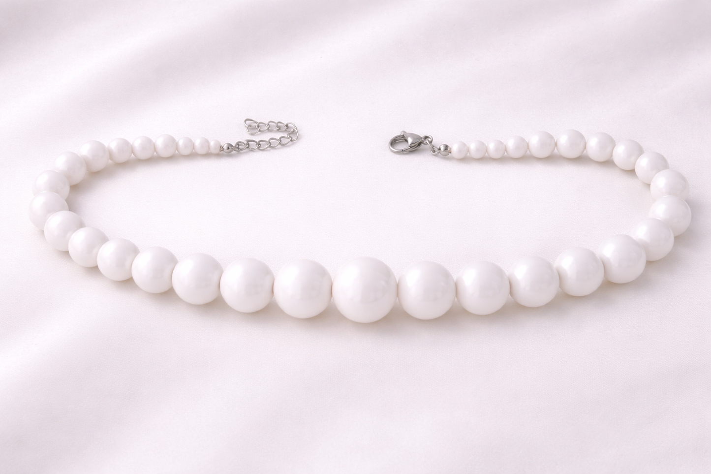 Elegant white statement necklace with smooth acrylic beads, designed to complement casual, office, and evening looks.