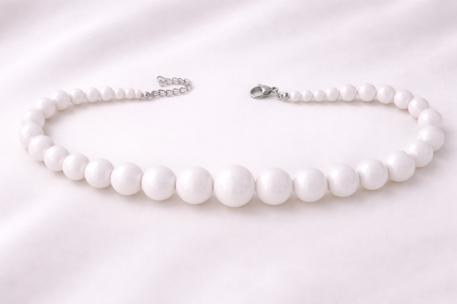 Elegant white statement necklace with smooth acrylic beads, designed to complement casual, office, and evening looks.
