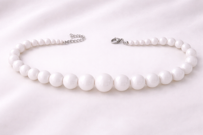 Elegant white statement necklace with smooth acrylic beads, designed to complement casual, office, and evening looks.