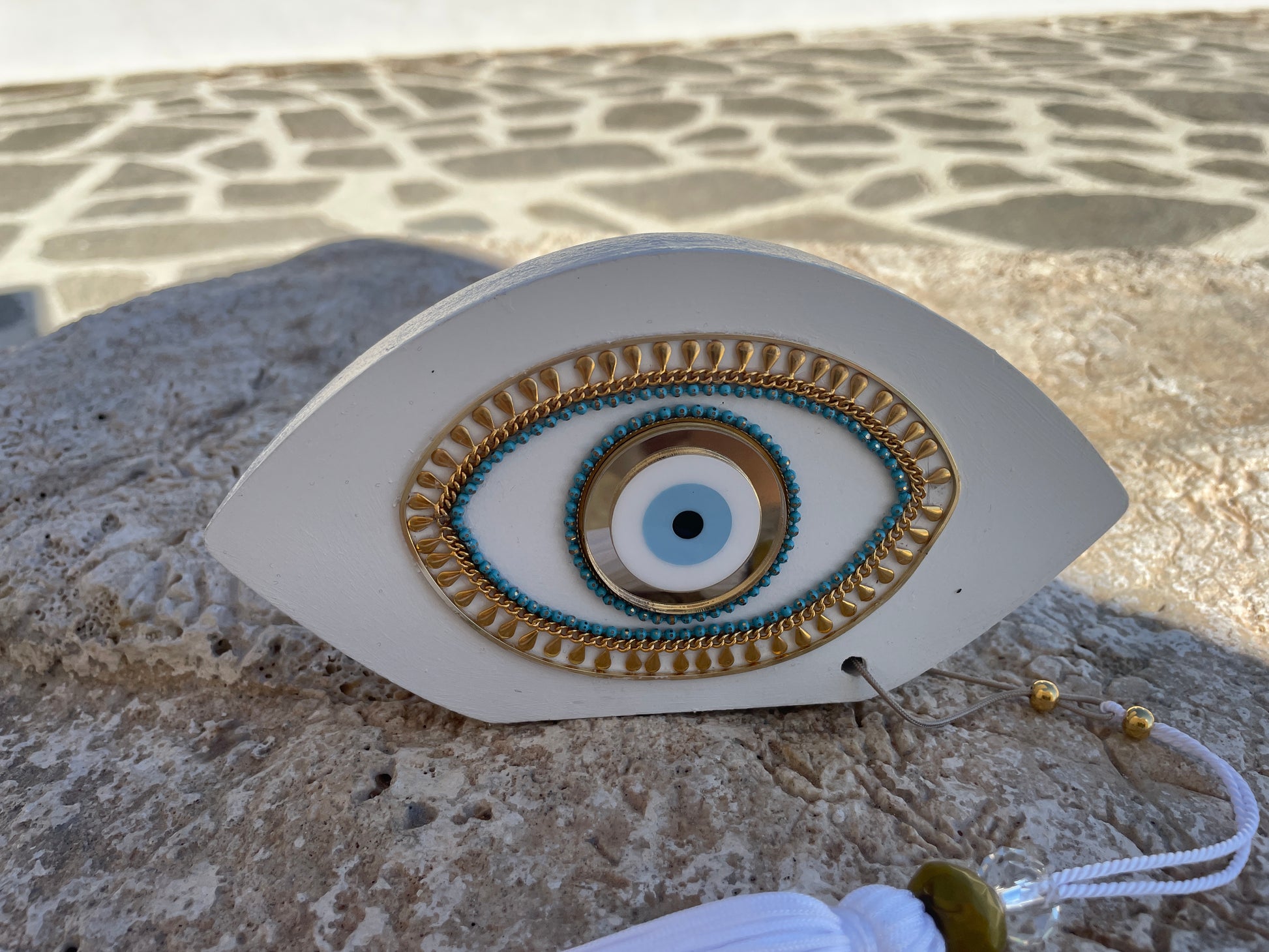 Decorative eye-shaped object with intricate designs on a stone surface