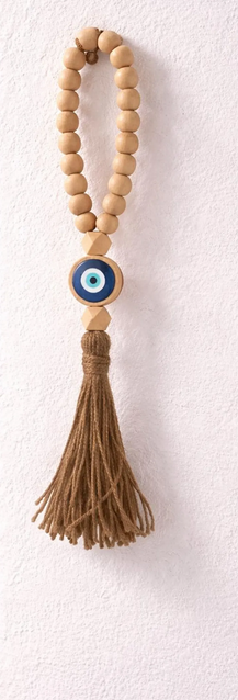 Decorative hanging with wooden beads and tassel on a white background
