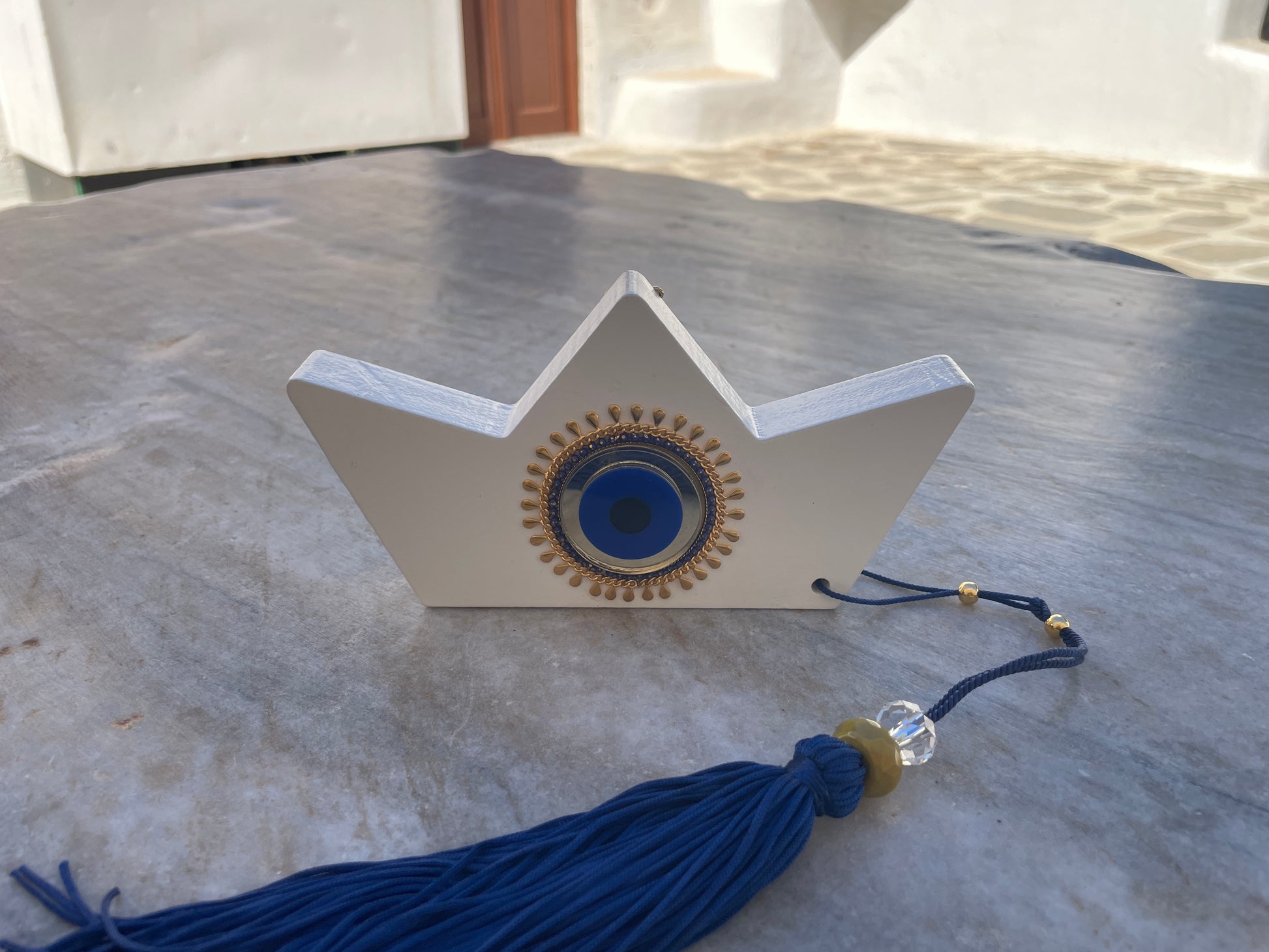 Decorative item with blue tassel on a marble surface